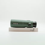 A pair of green binoculars displayed upright on a white branded stand against a clean white background.