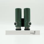 SWAROVSKI green cl pocket binoculars with white background on a stand.