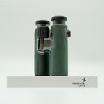 SWAROVSKI green cl pocket binoculars with white background on a stand.