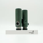 SWAROVSKI green cl pocket binoculars with white background on a stand.