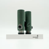 SWAROVSKI green cl pocket binoculars with white background on a stand.