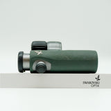 SWAROVSKI green cl pocket binoculars with white background on a stand.