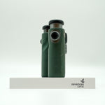 SWAROVSKI green cl pocket binoculars with white background on a stand.