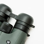 Pre-owned Vortex Kaibab HD 18x56 binoculars, objective side, three-quarter view on Vortex retail block - The Lookout, Prescott AZ